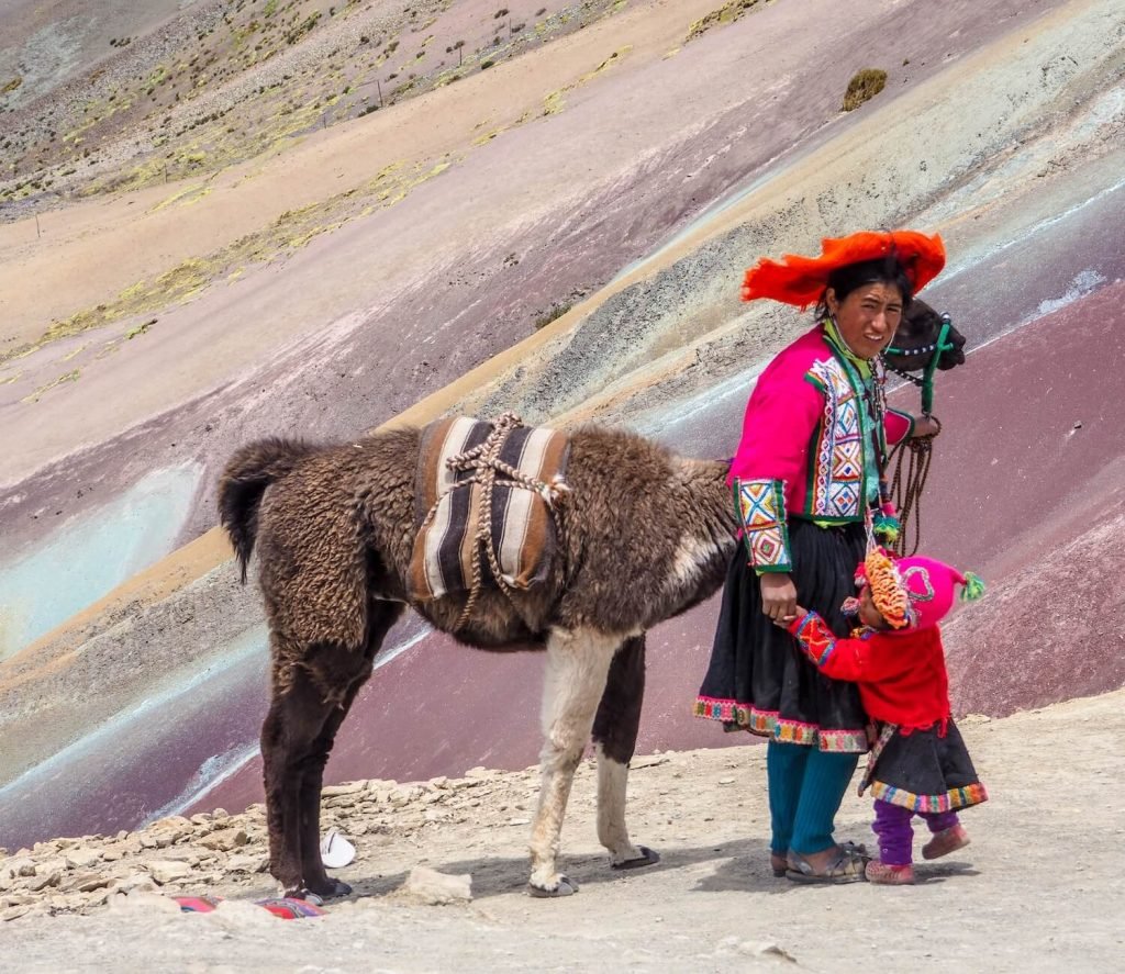 Alpaca and local people at Rainbow Moutain